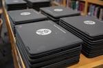 Stacks of Chromebooks wait to be assigned to students in the library of Benson Polytechnic High School, Portland, Ore., Aug. 27, 2024. Benson is a technical public high school that offers courses in subjects as wide-ranging as healthcare and radio broadcasting. PPS is looking to trim $40 million from the 2025-26 school year.