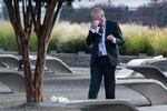 A man wipes his eyes as he walks through the 9/11 Pentagon Memorial on Wednesday, Sept. 11, 2024 in Washington.