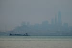 The San Francisco skyline is barely visible through smoke from wildfires Wednesday, Aug. 19, 2020, in this view from Sausalito, California. Thousands of people were under orders to evacuate in regions surrounding the San Francisco Bay Area Wednesday as nearly 40 wildfires blazed across the state amid a blistering heat wave now in its second week. Smoke blanketed the city of San Francisco.