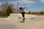 Erick Williams, a 16 year-old junior at Warm Springs High School, does a nollie kickflip during an afternoon skating session with his crew on April 30, 2023.