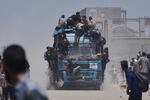 Palestinians hold onto an aid truck returning to Gaza City from the northern Gaza Strip on Tuesday.