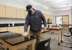 Areas that have been occupied by students at Reynolds High School in Troutdale, are cleaned and sprayed with disinfectant solution. Lead custodian, Ben Koskela wipes down a classroom worktable, March 26, 2021. Districts previously committed to distance learning have had to pivot under the governor's executive order to have schools open to in-person learning.