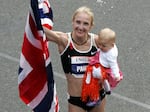 Paula Radcliffe celebrates with her daughter, Isla, after winning the women's division in the New York City Marathon on Nov. 4, 2007. 
