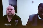 Jeremy Williams, left, appears virtually for his first court appearance on Sept. 17, 2025 in Kelso, Wash. The school principal is charged with possessing and distributing files depicting sexual abuse against minors.