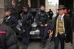 Police officers block an access to the Louvre museum after a robbery Sunday, Oct. 19, 2025, in Paris.