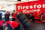 Firestone Racing employees mount tires on wheels for all of the IndyCar teams. The two types of tire are red and black, which are different tire compounds, giving different performance values.