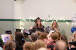 Bella Kjellander waves to the crowd during Metropolitan Learning Center’s graduation on Friday, June 5, in Portland, Ore. Earlier this year, Portland Public Schools planned to end the high school program at the K-12 alternative school, but later reversed the decision.