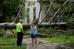 Jackie Jecmenek, right, talks with city worker Bobby Head as she stands in front of her neighbor's home after Beryl passed, Monday, July 8, 2024, in Bay City, Texas.