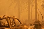 Newly filed court documents show state officials asked PacifiCorp to shut down power lines in 2020, fearing they could pose a fire hazard. Those power lines are central to a class-action lawsuit alleging the power lines started multiple Labor Day fires that year that devastated several parts of the state. In this file photo, a person surveys the damage to a neighborhood burned in the Santiam Fire near Gates, Ore., Sept. 9, 2020.