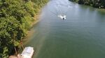 An aerial image illustrates erosion along the bank of the Willamette River.