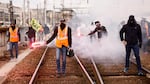 Railway workers demonstrate on the tracks at the Gare de Lyon train station on Tuesday in Paris. A new round of strikes and demonstrations is planned against the unpopular pension reforms that, most notably, push the legal retirement age from 62 to 64.