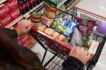 FILE - Jaqueline Benitez, who depends on California's SNAP benefits to help pay for food, shops for groceries at a supermarket in Bellflower, Calif., Feb. 13, 2023.