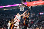 Portland Trail Blazers center Donovan Clingan (23) reaches out to block a basket from Atlanta Hawks forward Jalen Johnson (1) during the first half of an NBA basketball game on Thursday, Jan. 15, 2026, in Portland, Ore.