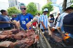 Matias Videla, of Dallas, a supporter of Argentina, checks meat on his grill during a rally ahead of his team's World Cup Group J soccer match against Austria, Sunday, June 21, 2026, in Dallas.