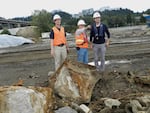 Erik Bakkom (left), Paul Fishman (center), and Matt French (right) discuss their work as they stand near parts of dismantled ships fished out of the Willamette River on the Zidell Waterfront cleanup site. 