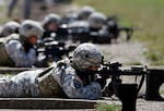 FILE - Female soldiers from 1st Brigade Combat Team, 101st Airborne Division train on a firing range while testing new body armor in Fort Campbell, Ky., Sept. 18, 2012.