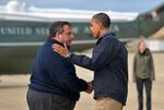 President Barack Obama (R) is greeted by New Jersey Governor Chris Christie upon arriving in Atlantic City, New Jersey, on October 31, 2012 to visit areas hit by Superstorm Sandy.