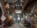 Intermountain Power Agency spokesperson John Ward walks through the coal plant near Delta, Utah, in 2022.