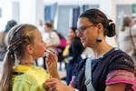 A young ice skater has makeup adjusted, May 31, 2026, at the final ice performance at the Lloyd Center Ice Rink.
