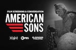 Film Screening & Conversation 'American Sons' with OPB, PBS, and Elsinore Theatre. A soldier in desert fatigues leans over a boulder holding an American flag in their hands.