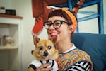 Graphic novelist, Nicole Georges, and her dog, Ponyo, seated in her Los Angeles studio.