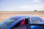 Farmworker Patricia Mendoza sits in her car next to a watermelon field in Eltopia, Wash., on June 26, 2023.