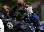 Law enforcement officers arrest 31 members of the white nationalist group Patriot Front on suspicion of conspiracy to riot after they were removed from a U-Haul truck near the LGBTQ+ community's "Pride in the Park" event in Coeur d'Alene, Idaho, on June 11, 2022.