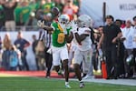 Ohio State wide receiver Jeremiah Smith (4) makes a catch while Oregon defensive back Dontae Manning (8) defends in the first half in the quarterfinals of the Rose Bowl College Football Playoff on Wednesday, January 1, 2025, in Pasadena, California.