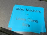 Portland Association of Teachers members held signs reading "More Teachers = Lower Class Size" during a board meeting April 26, 2022. The district has planned for staffing cuts, citing declining enrollment, but said there will be no layoffs.