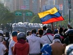 Police block protesters during demonstrations against the official election results declaring President Nicolas Maduro's reelection, the day after the vote at a highway in Caracas, Venezuela, Monday, July 29, 2024.