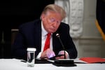 In this Thursday, June 18, 2020 file photo, President Donald Trump looks at his phone during a roundtable with governors on the reopening of America's small businesses, in the State Dining Room of the White House  in Washington. Though stripped of his Twitter account for inciting rebellion, President Donald Trump does have alternative options of much smaller reach.