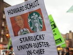 People hold signs while protesting in front of Starbucks on April 14, 2022 in New York City. Activists gathered to protest Starbucks' CEO Howard Schultz anti-unionization efforts and demand the reinstatement of workers fired for trying to unionize.