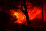 Firefighters stage in front of the advancing Palisades Fire in the Pacific Palisades neighborhood of Los Angeles.