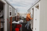 In this provided photo from 2024, Church at the Park staff member Melinda Brock sanitizes the guest showers at the nonprofit’s adult-only shelter, Village of Hope, in Salem, Ore.