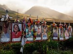 Photos of victims are displayed under white crosses at a memorial for victims of the August 2023 wildfire, above the Lahaina Bypass highway on Dec. 6, 2023 in Lahaina, Hawaii.