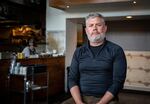 Restauranteur Nate Tilden poses for a portrait in the empty dining room of his award-winning restaurant Clyde Common in Portland, Ore., on Tuesday, May 12, 2020. Tilden, who opened the restaurant on the ground level of the Ace Hotel in 2007, shuttered it when the coronavirus outbreak reached Oregon.