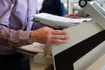 Michael Lui feeds test ballots into a ballot counting maching in Bend, Ore., on Oct. 14, 2024.