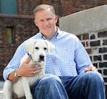 Barton O'Brien, shown with his dog Walter, runs the BAYDOG company, which sells harnesses, life-jackets and other pet supplies. He imports products from China, India and Vietnam, and double-digit tariffs have been challenging for his business.