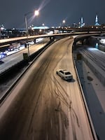 A driver abandons their car on Interstate 5 after a winter storm cripples Portland's evening commute, Dec. 14, 2016.