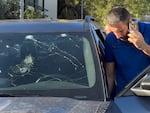 A Lebanese police officer inspects a car damaged by an exploding pager in Beirut on Tuesday. Hundreds of pagers belonging to Hezbollah members exploded simultaneously. The group blamed Israel. 