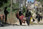 Palestinians collect their belongings from their evacuated homes after the Israeli army issued a number of short term access permits for residents of the occupied West Bank refugee camp of Tulkarem, Wednesday, June 17, 2026.