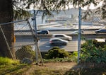 FILE - The I-5 freeway is seen through the fencing at the back of Harriet Tubman Middle School in North Portland, April 9, 2021. 