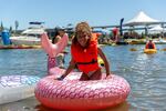 Florence Ajunwa from Abington, Pa. cools off in the Willamette River in her mermaid tail float. 