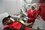 People donate blood for those who were injured by their exploded handheld pagers, at a Red Cross center, in the southern port city of Sidon, Lebanon, Tuesday, Sept. 17, 2024.