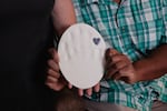 Bobbie and DeForrest hold a white handprint from their son, Christian Williams.