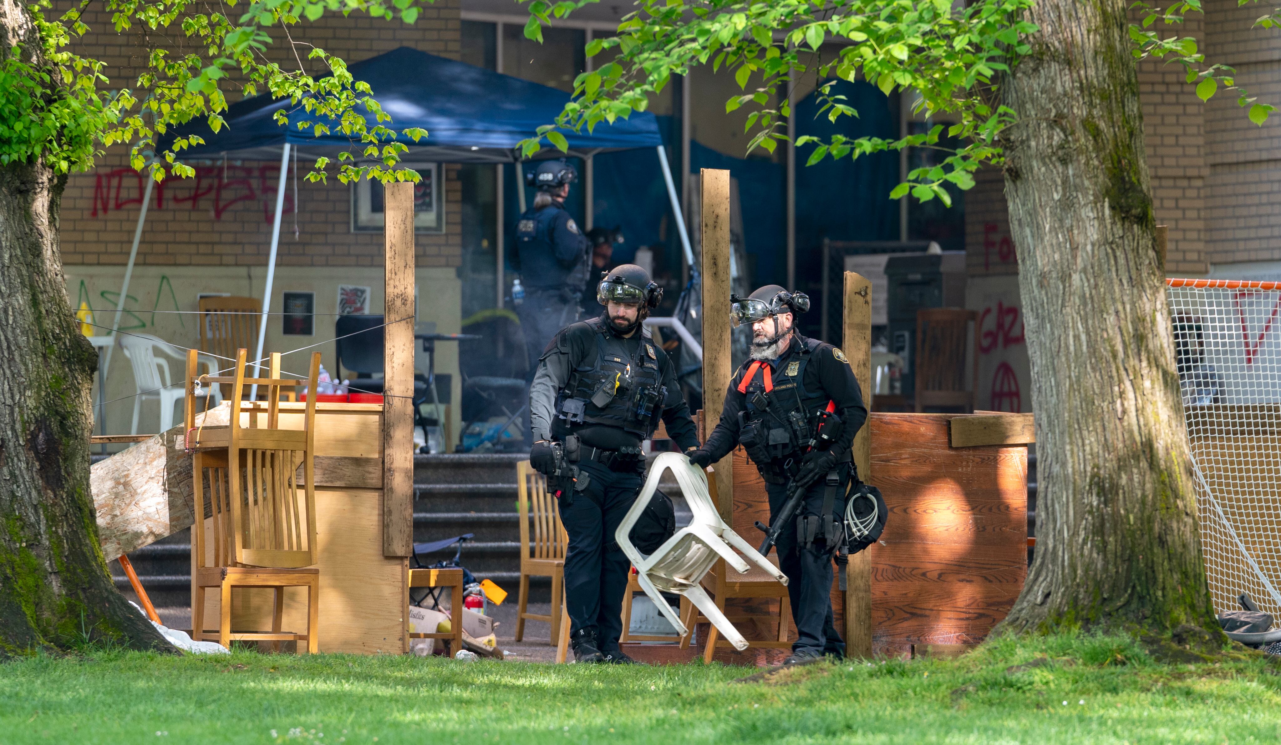 Law enforcement teams clear items from outside Portland State University’s Branford Price Millar Library, May 2, 2024. People protesting Israel's role in the war in Gaza had occupied the library since Monday evening.