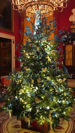 Butterflies spiral out of a tree in the Red Room Monday, Dec. 1, 2025, during a tour of the Christmas decorations inside the White House in Washington, D.C.