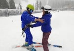 Ski instructor Destinie Davis helps a participant of Open Slopes PDX keep their balance at Mt. Hood Meadows Ski Resort.