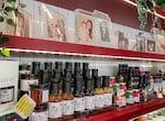 Photos of Lisa Tran, her parents, and other family members line a shelf above Tân Tân sauces for sale at Tân Tân Café and Delicatessen, Beaverton, Ore., June 13, 2025. 