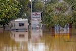 A couple of RVs are abandoned in the flooded Ingles parking lot due to the torrential rains from Hurricane Helene, Saturday, Sept. 28, 2024, in Morganton, N.C.